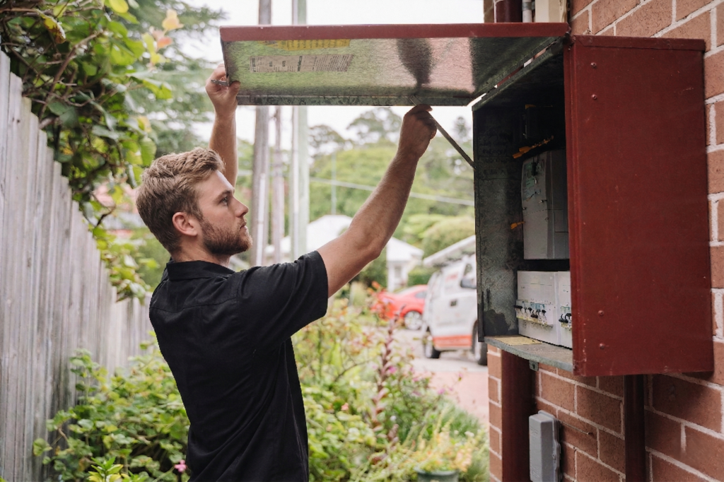 Electrician installing downlights in a North Strathfield home